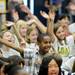 Logan Elementary School fifth-grader Abdikhani Said waves his arms while teachers dance in a surprise flash mob performance during a year-end assembly on Friday morning. Melanie Maxwell I AnnArbor.com